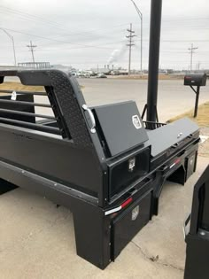 the flatbed truck bed is parked on the side of the road