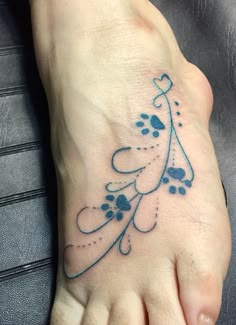 a foot with a blue tattoo on it