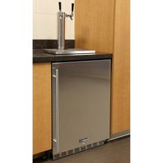 a stainless steel dishwasher sitting on top of a counter next to a sink