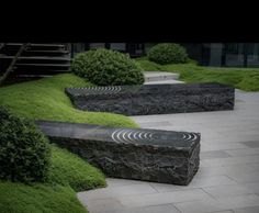 a stone bench sitting in the middle of a garden