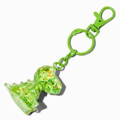 a green keychain with a dog shaped object on it's back end