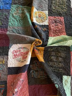 the quilt is made up and has many different designs on it, including one with a yellow ribbon