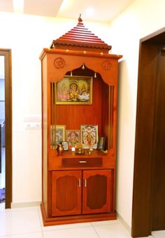 a wooden cabinet with pictures on it in a room