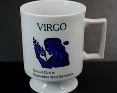 a white coffee cup with the words virgo on it and an image of a woman holding a bird