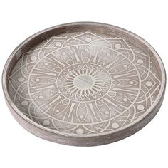 a white bowl with an intricate design on the bottom and sides, sitting in front of a white background