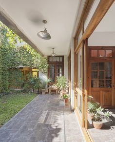 the back porch is lined with potted plants