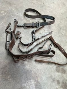 an assortment of old tools are laying on the floor