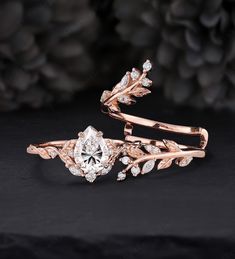 two rose gold wedding rings, one with a diamond center and the other with leaves