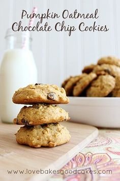 pumpkin oatmeal chocolate chip cookies stacked on top of each other next to a glass of milk