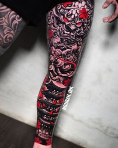 a man's leg covered in tattoos and red ink