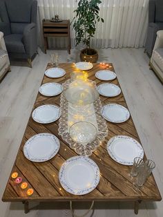 a table with plates and candles on it