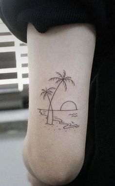 a small palm tree tattoo on the arm