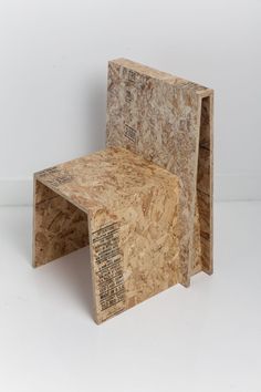 two pieces of plywood sitting on top of each other in front of a white wall