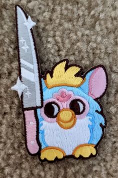 a patch with a cartoon character holding a knife in it's right hand and wearing a crown