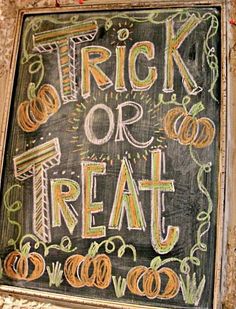 a chalk board with writing on it that says trick or treat