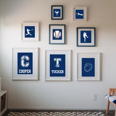 four framed baseball pictures hang on the wall above a child's chair in a playroom