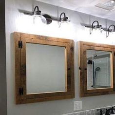 a bathroom with two sinks and three mirrors