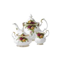 three pieces of porcelain tea set with roses on them and gold trimming around the edges