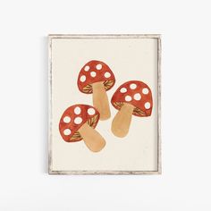 three mushrooms are painted on a white background in an old - fashioned wooden frame, which is hung on the wall