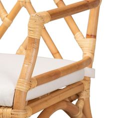 a bamboo chair with a white cushion on it