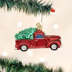 a red truck ornament hanging from a christmas tree