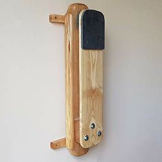 a piece of wood hanging from the side of a wall