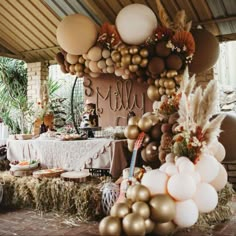 a table is set up with balloons and decorations