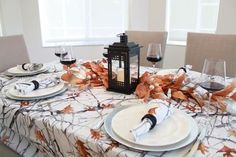 a table set with place settings and wine glasses