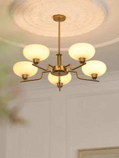 a chandelier hanging from the ceiling in a room