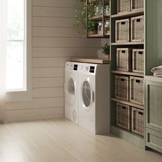 a washer and dryer in a room with wooden shelves on either side of the wall