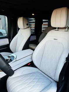 the interior of a car with white leather seats