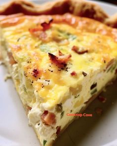 a close up of a slice of quiche on a plate