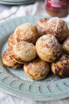 powdered sugar covered pastries on a blue plate