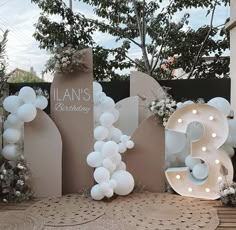 balloons are arranged around the letters for a birthday party