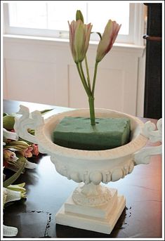 a vase with flowers in it sitting on a table