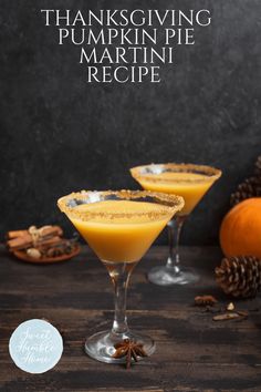 two glasses filled with pumpkin pie martinis on top of a wooden table next to pine cones