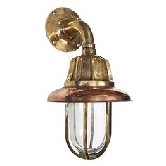 an old fashioned brass wall light on a white background