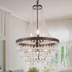 a chandelier hanging from the ceiling in a living room