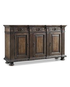 an antique style sideboard with carvings on the front and sides, in dark wood