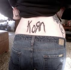 the back of a woman's stomach with words written on her lower body and bottom