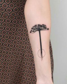 a woman's arm with a black and white tattoo on it