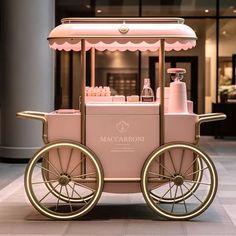 a pink and gold cart sitting in front of a building