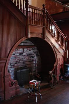 a living room with a fire place next to a stair case