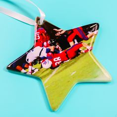 a star shaped ornament with an image of football players on the field in it