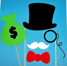 a man with a top hat, mustache and eyeglasses is standing next to a bag of money