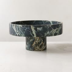 a marble bowl sitting on top of a white table