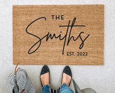 someone is standing in front of a door mat that says the smiths