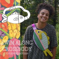 a young man holding a stuffed animal in front of a colorful wall with an image of a fish on it