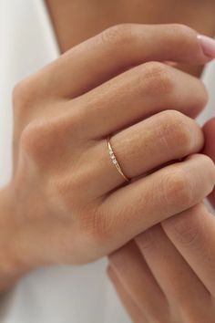 a woman's hand with a diamond ring on it