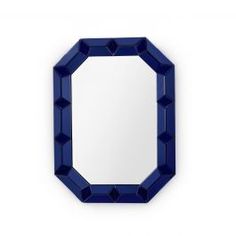 a mirror that is on the wall next to a white wall with a blue frame